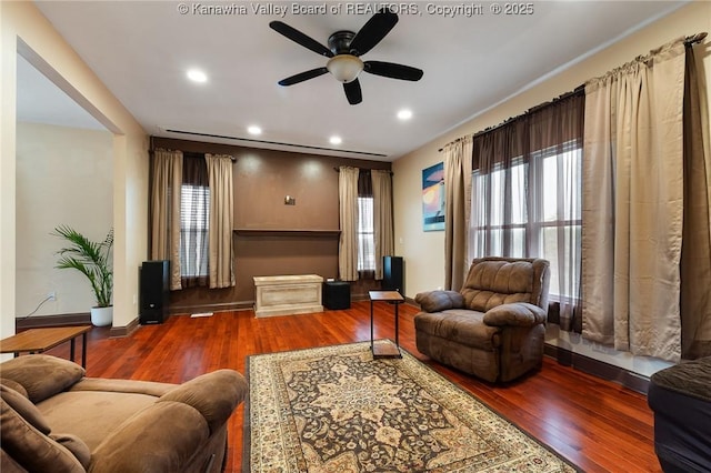 living room with ceiling fan and wood-type flooring