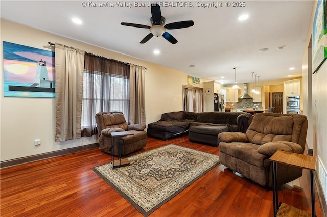 living room with hardwood / wood-style floors and ceiling fan