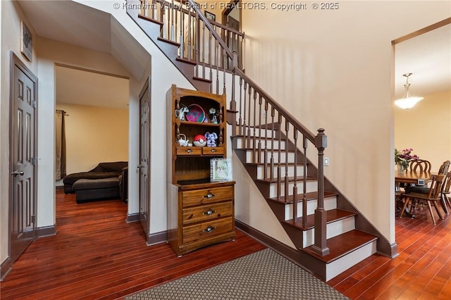 stairs featuring hardwood / wood-style floors