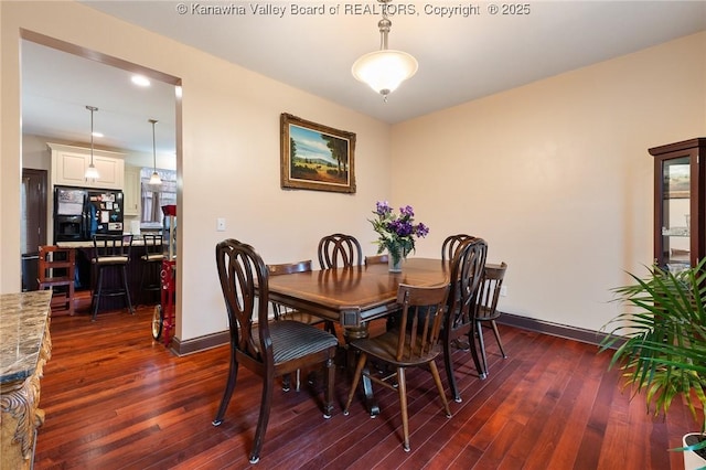 dining space with dark wood-type flooring