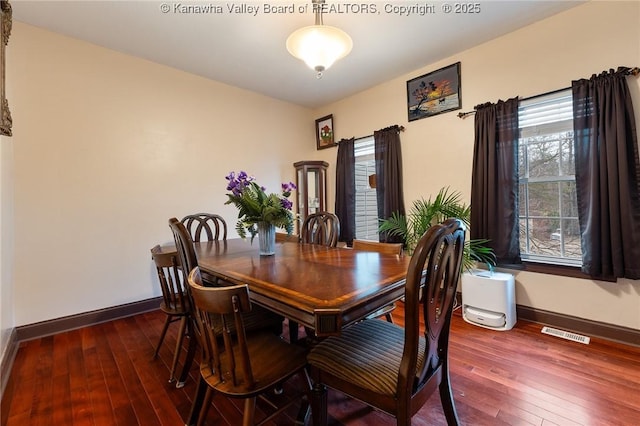 dining room with a healthy amount of sunlight and hardwood / wood-style floors