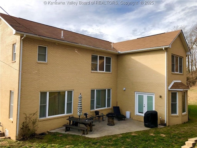 back of house with french doors, a patio, and a lawn