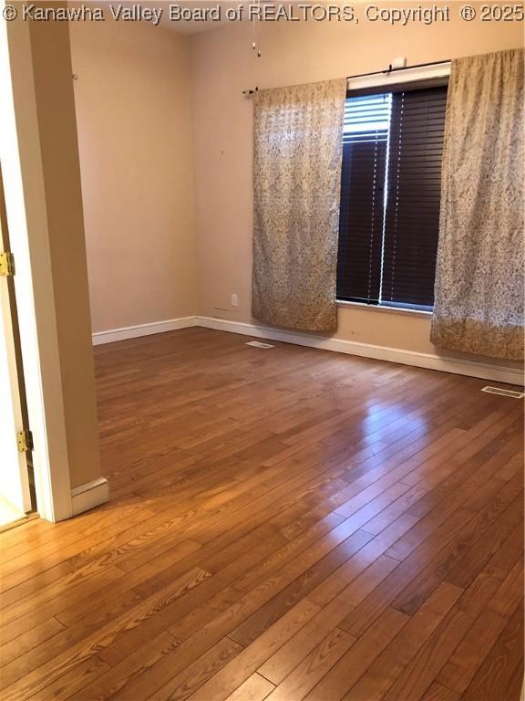 spare room featuring hardwood / wood-style flooring