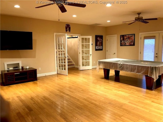 game room featuring ceiling fan, billiards, light hardwood / wood-style floors, and french doors