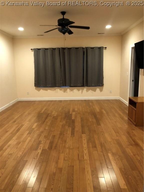 empty room with crown molding, ceiling fan, and hardwood / wood-style floors