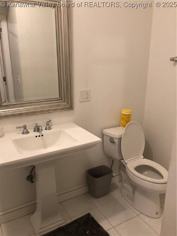 bathroom featuring toilet and tile patterned flooring