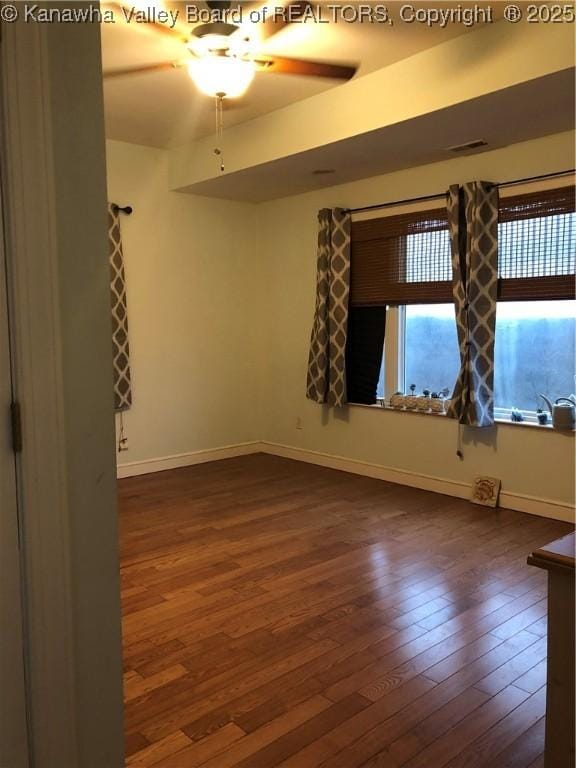 spare room featuring dark hardwood / wood-style floors and ceiling fan