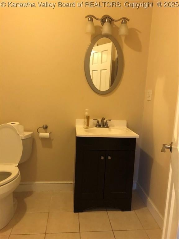 bathroom featuring vanity, toilet, and tile patterned flooring