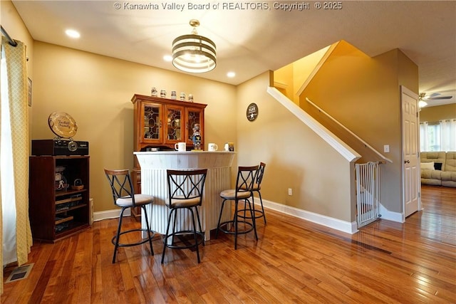 bar with dark wood-type flooring