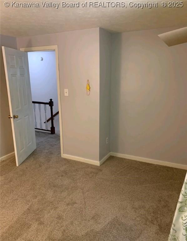 spare room with carpet floors and a textured ceiling