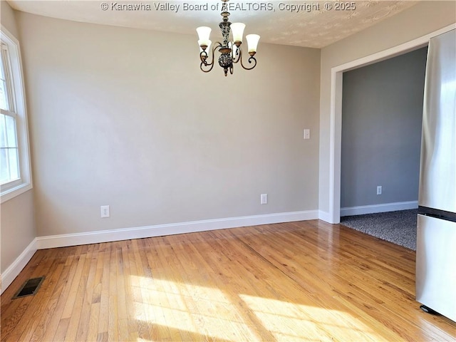 100 Oak Ridge Ln, Huntington, WV 25704 - empty room with an inviting chandelier and hardwood / wood-style flooring