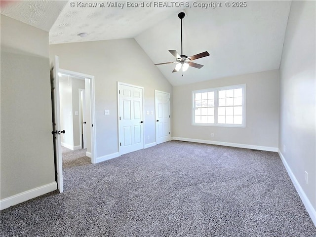 100 Oak Ridge Ln, Huntington, WV 25704 - unfurnished bedroom featuring dark colored carpet, ceiling fan, high vaulted ceiling, and two closets