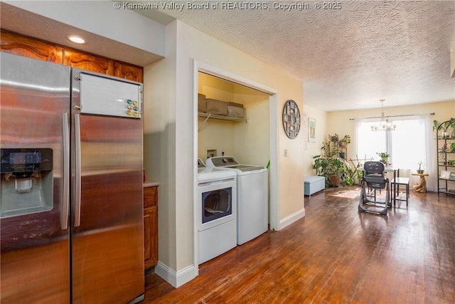 kitchen with separate washer and dryer, decorative light fixtures, dark hardwood / wood-style flooring, and stainless steel refrigerator with ice dispenser