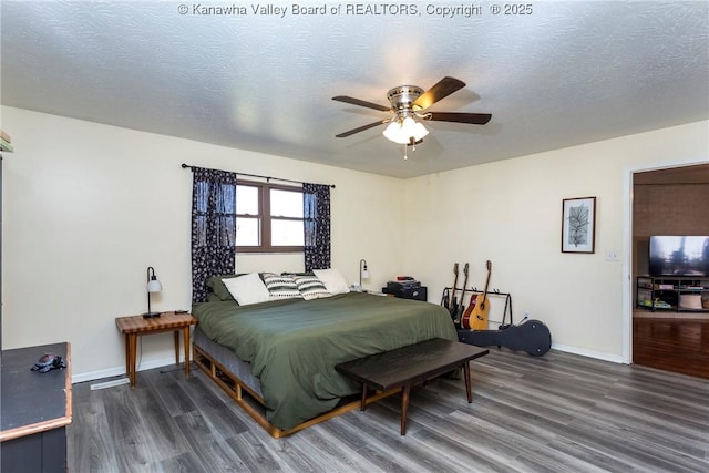 bedroom featuring dark hardwood / wood-style flooring and a textured ceiling