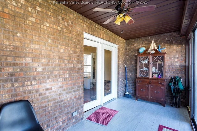 sunroom featuring ceiling fan and wood ceiling