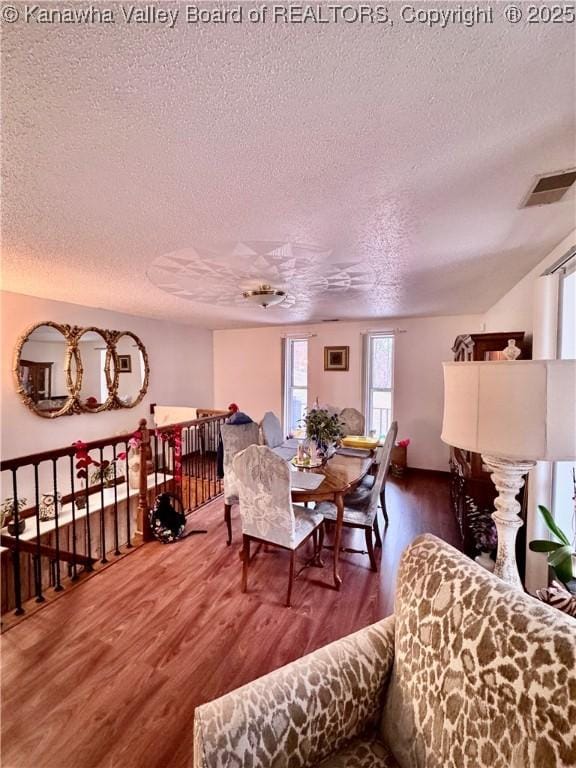 dining area featuring dark hardwood / wood-style floors and a textured ceiling