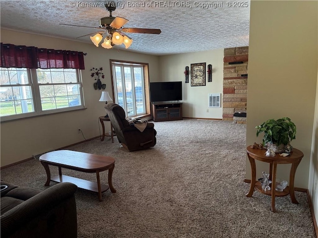 carpeted living room featuring a textured ceiling and ceiling fan