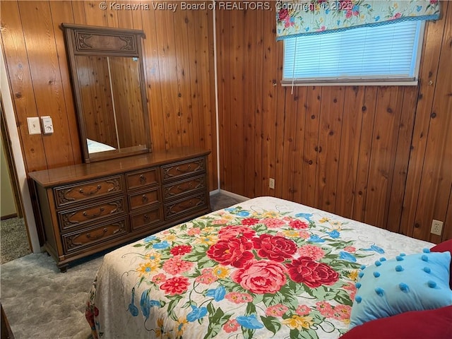 bedroom with wood walls and carpet floors