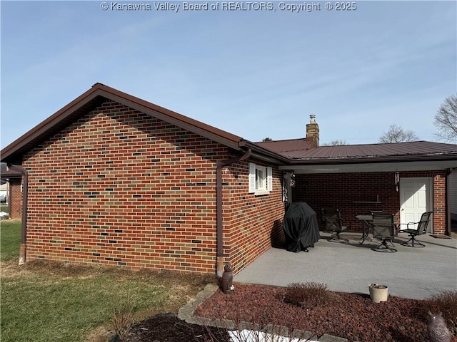 view of side of home with a patio