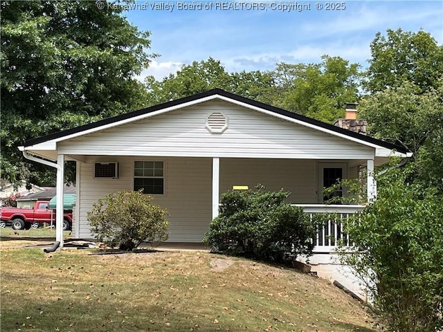 view of side of property featuring a yard and a carport