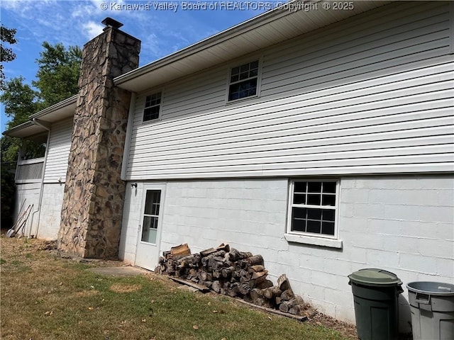 view of side of property with a lawn