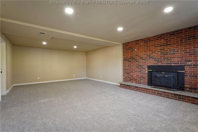 unfurnished living room with carpet and a fireplace