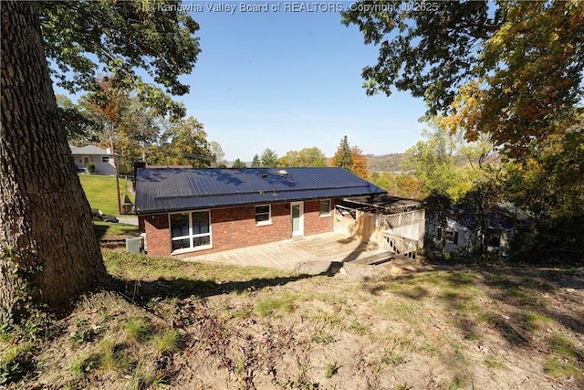 rear view of property with central air condition unit