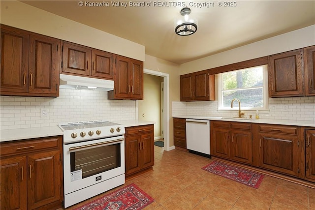 kitchen with white appliances, light tile patterned floors, sink, and backsplash