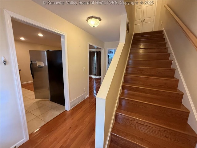 stairway featuring hardwood / wood-style floors