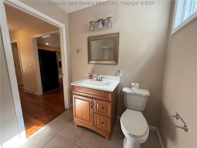 bathroom featuring tile patterned floors, vanity, and toilet