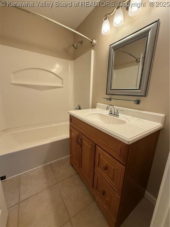 bathroom featuring vanity, shower / bathtub combination, and tile patterned floors