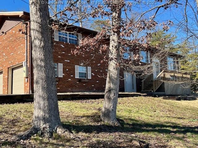 view of property exterior with a yard and a garage