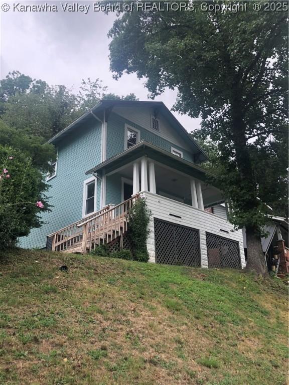 view of home's exterior with a yard and a garage