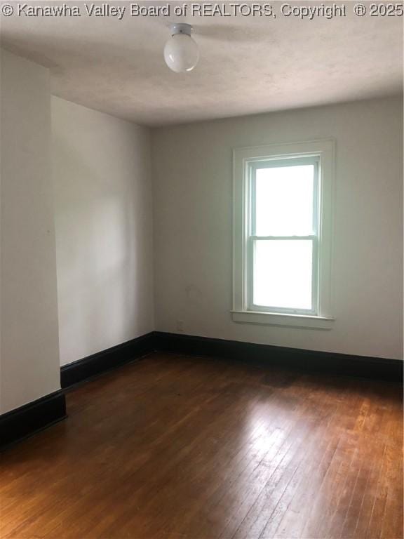 empty room featuring dark hardwood / wood-style flooring