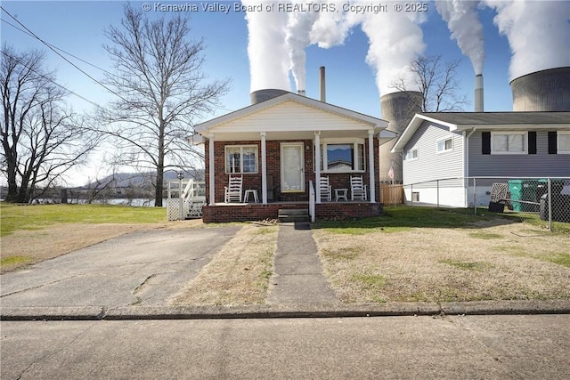 view of front of property with covered porch and a front yard