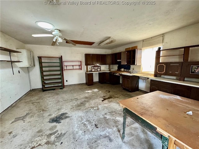 kitchen featuring ceiling fan and dark brown cabinetry