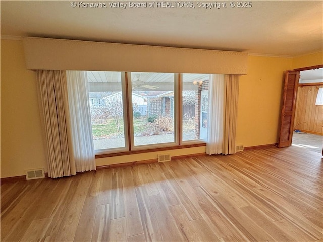 unfurnished room featuring ornamental molding and hardwood / wood-style floors