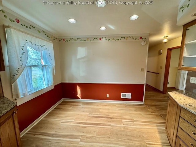 unfurnished room with light hardwood / wood-style flooring