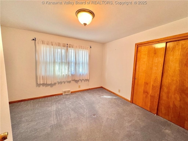 unfurnished bedroom with carpet floors and a closet