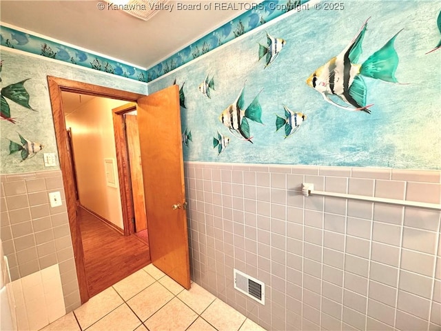 bathroom with tile walls and tile patterned flooring