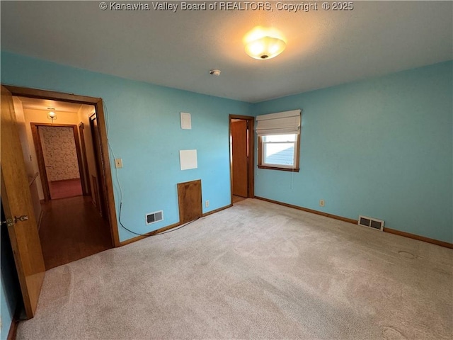 unfurnished bedroom featuring light carpet