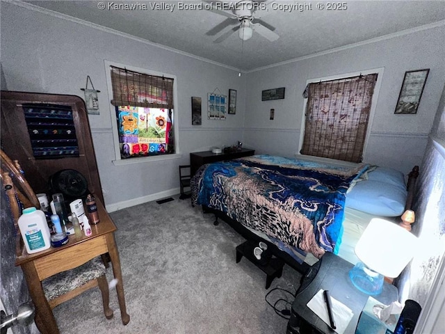 bedroom with crown molding, baseboards, ceiling fan, and carpet flooring