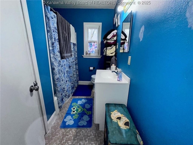 bathroom with toilet, tile patterned flooring, vanity, and a shower with curtain