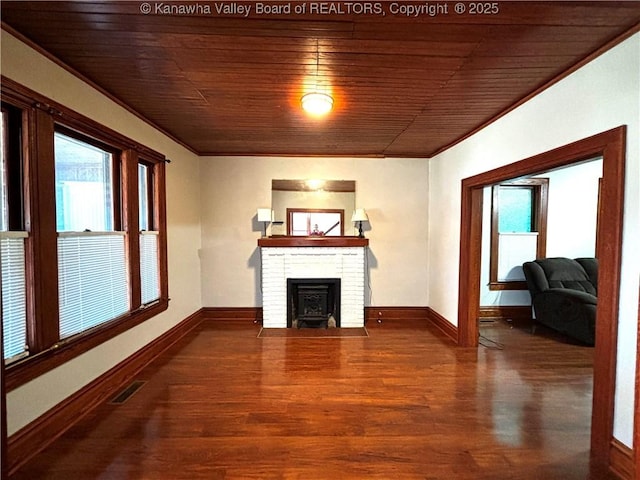 unfurnished living room featuring dark wood-style floors, a wealth of natural light, visible vents, and baseboards