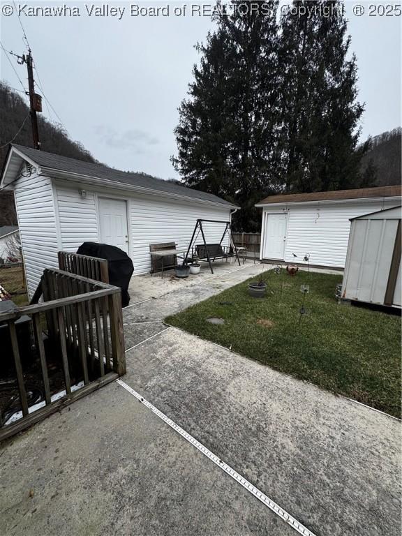 81 Amburgey Ln, Amherstdale, WV 25607 - exterior space with a storage shed, a patio, and an outdoor structure