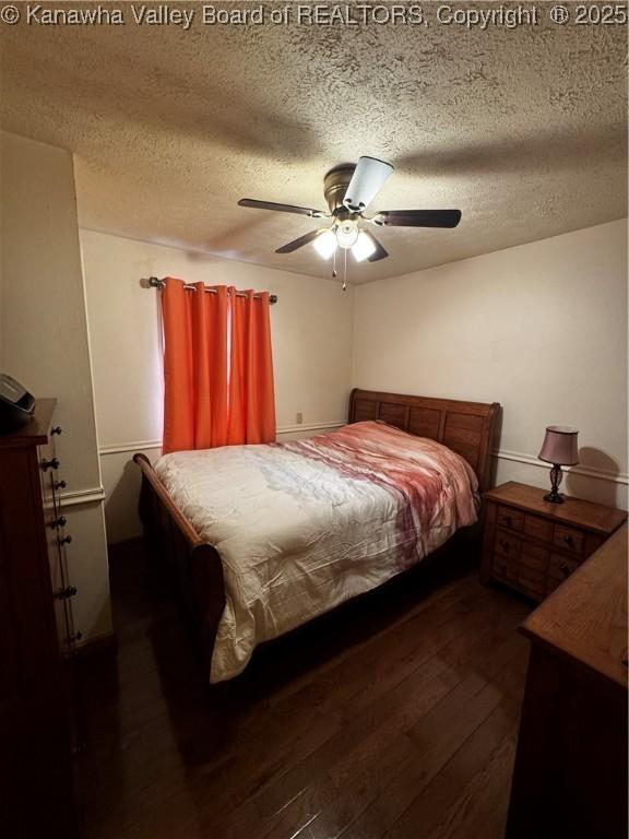 81 Amburgey Ln, Amherstdale, WV 25607 - bedroom with ceiling fan, dark wood-style floors, and a textured ceiling