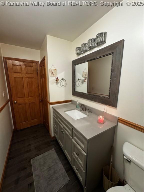 81 Amburgey Ln, Amherstdale, WV 25607 - bathroom featuring baseboards, vanity, toilet, and wood finished floors