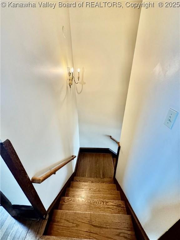 stairway with baseboards and wood finished floors