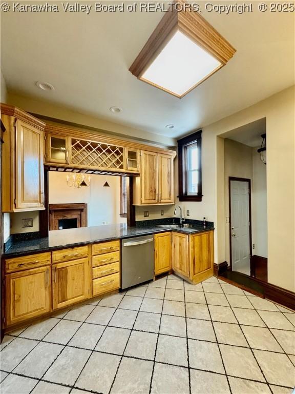 kitchen featuring dishwasher, light tile patterned floors, dark countertops, and glass insert cabinets