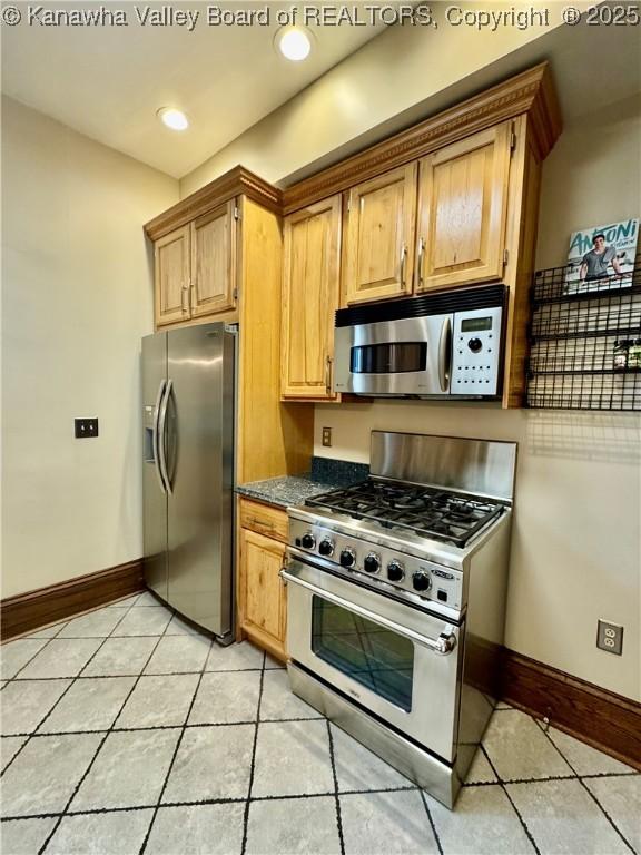 kitchen featuring stainless steel appliances, recessed lighting, baseboards, and light tile patterned floors